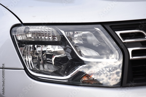 shiny headlight on a  gray car