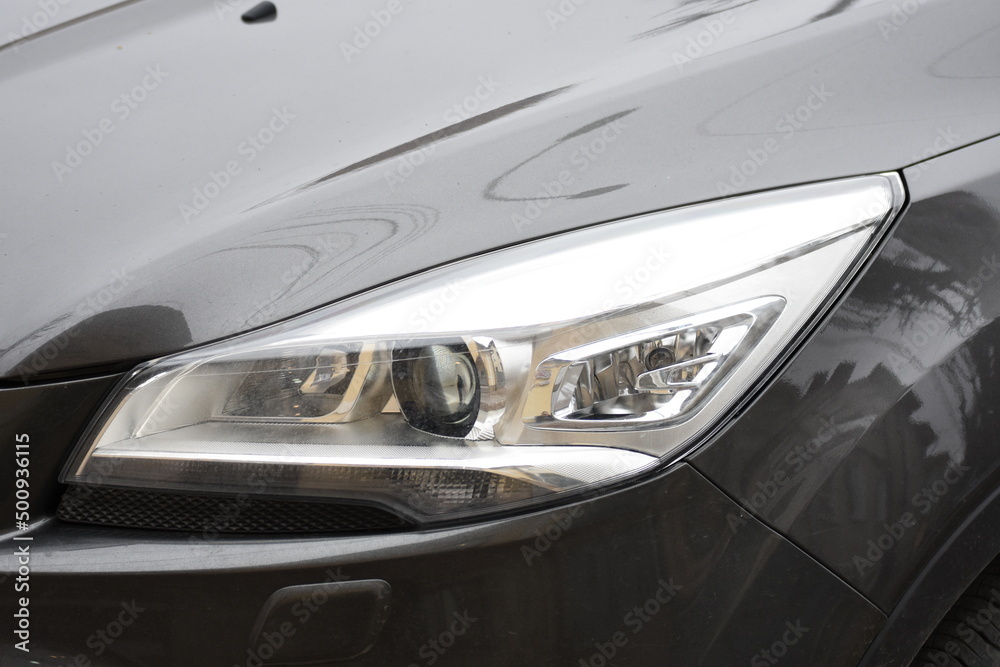 Car's exterior detail,new headlight on a  white silver car