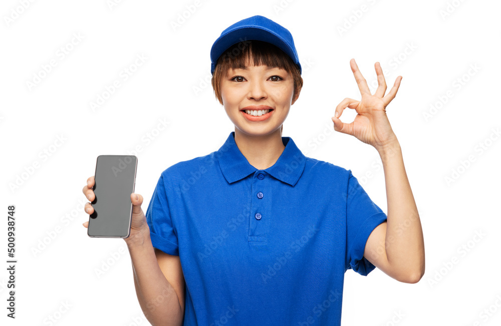 profession, job and people concept - happy smiling delivery woman in blue uniform with smartphone showing ok gesture over white background profession, job and people concept - happy smiling delivery woman in blue uniform with smartphone showing ok gesture over white background