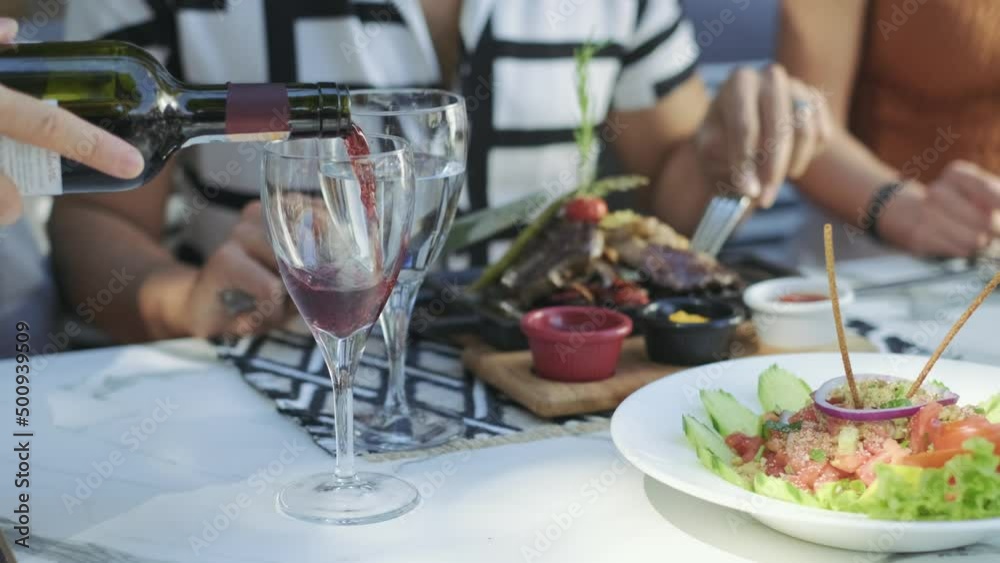 The waiter is pouring red wine to a wine glass in restaurant. 4K. Slow motion, close up.
Waiter pours red wine from bottle with napkin into clean wine glass. The waiter is pouring red wine to a wine glass in restaurant. 4K. Slow motion, close up.
Waiter pours red wine from bottle with napkin into clean wine glass.