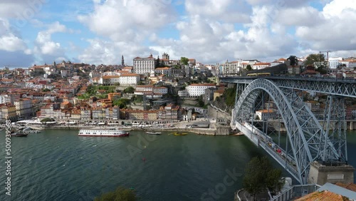 Cityscape shot of Dom Luís I Bridge –  double-deck metal arch bridge that spans the River Douro between the cities of Porto and Vila Nova de Gaia in Portugal photo