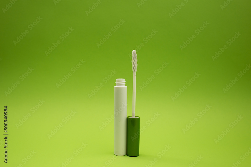 Mascara on a green background, monochrome Mascara on a green background, monochrome