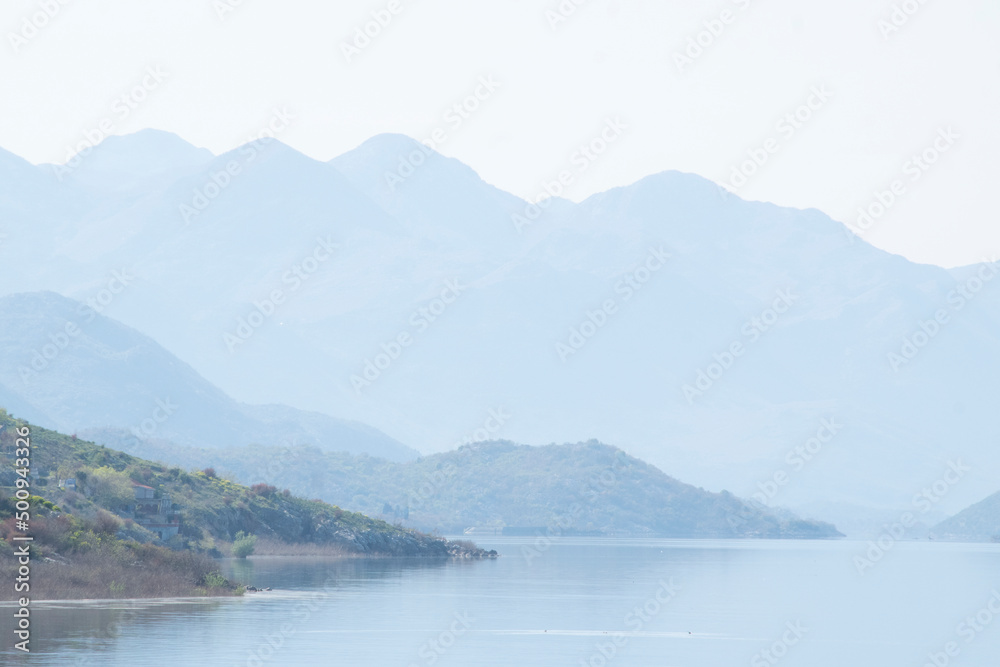 Scenic view of calm lake waters and mountains range