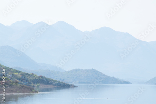 Scenic view of calm lake waters and mountains range