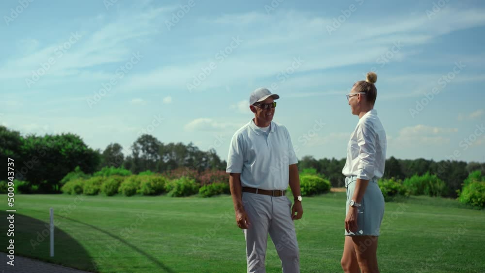 Two golfers talking sport on course field. Golf players chat on fairway grass. Two golfers talking sport on course field. Golf players chat on fairway grass.