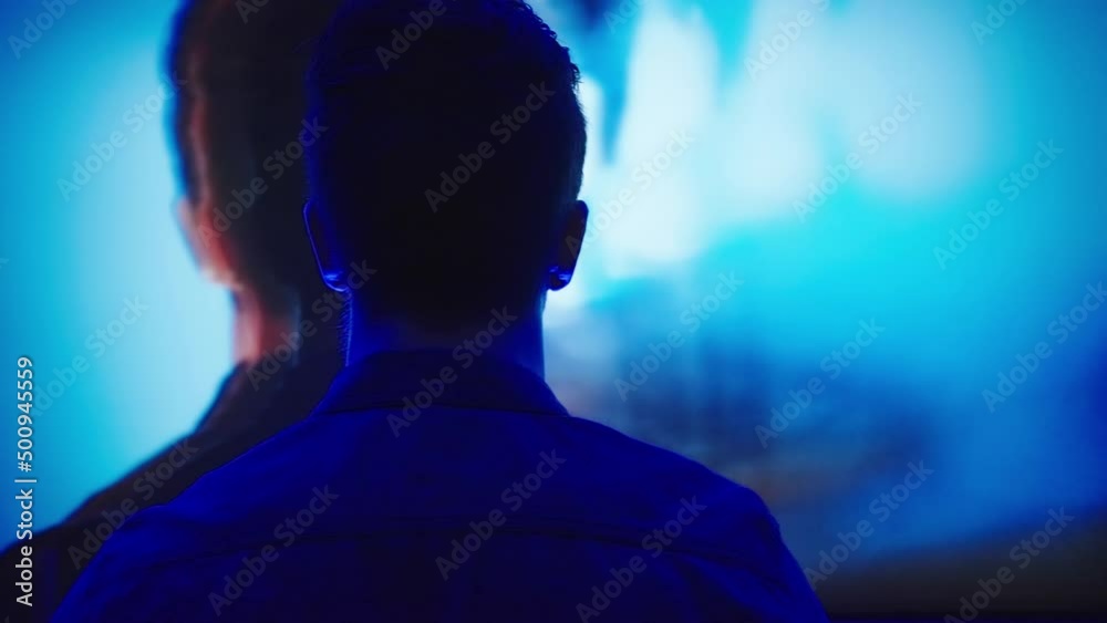 Male silhouette from back move left and right with flash blue and red light 4K