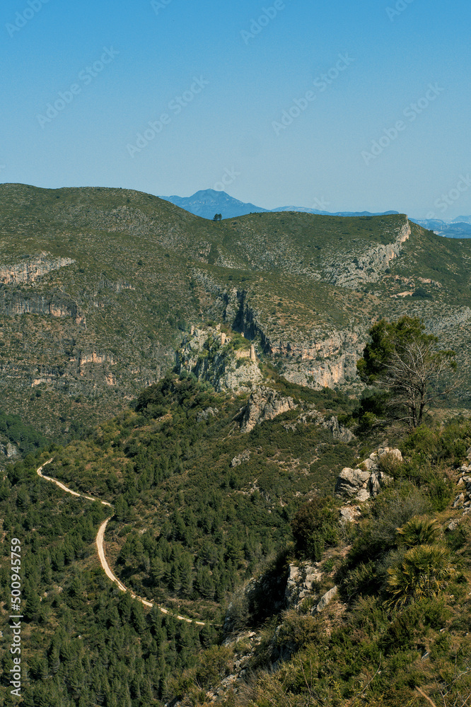 Road and castle ruins in the mountains