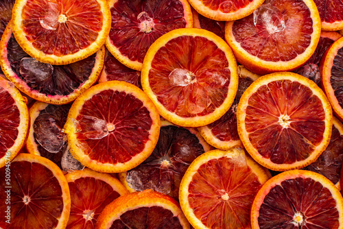 Fruit background with blood oranges and ice, delicious sweet fruit, top view