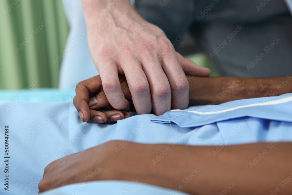 Obraz premium Closeup of holding hands while sick , Hand of doctor touching old woman in hospital