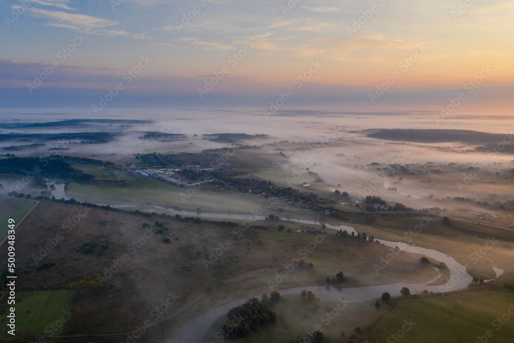 Foggy sunrise landscape. Aerial view of Moscow river near by Mozhaysk, Moscow Oblast, Russia.