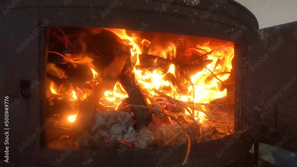 A blazing fire in a turkish metal oven or dome stove, the so called Katmer or Gözleme Sac. HD recording in SlowMotion with original 240 fps close up A blazing fire in a turkish metal oven or dome stove, the so called Katmer or Gözleme Sac. HD recording in SlowMotion with original 240 fps close up