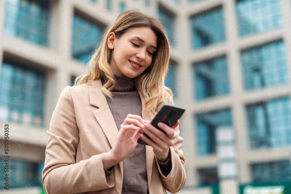 Business woman using phone to send message Business woman using phone to send message