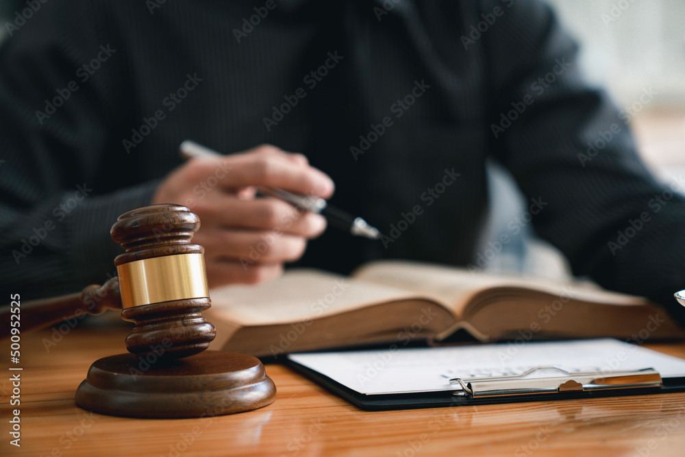 Attorney reading law code, studying constitution to protect human rights closeup, Male lawyer or judge working with Law books, gavel