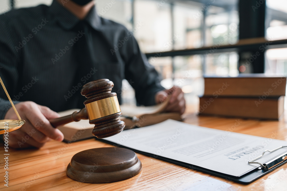 Lawyer or judge holding Hammer prepares to judge the case with justice, and litigation, scales of justice, law hammer, Legal consulting services, Concept of litigation, and legal services. Lawyer or judge holding Hammer prepares to judge the case with justice, and litigation, scales of justice, law hammer, Legal consulting services, Concept of litigation, and legal services.