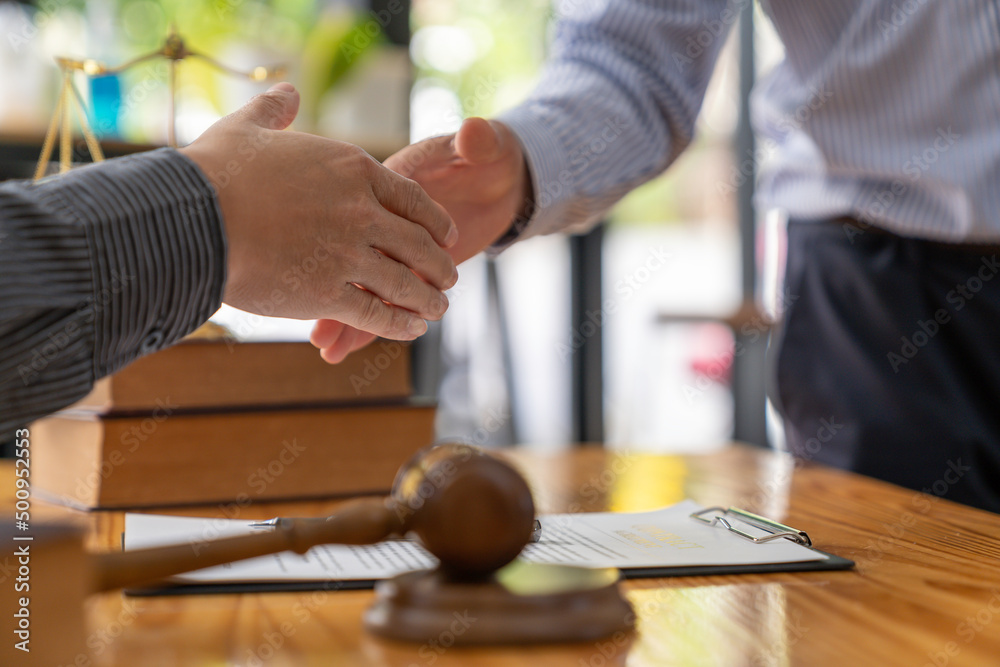 Lawyers shake hands with business people to seal a deal with partner lawyers. or a lawyer discussing contract agreements, handshake concepts, agreements, agreements Lawyers shake hands with business people to seal a deal with partner lawyers. or a lawyer discussing contract agreements, handshake concepts, agreements, agreements