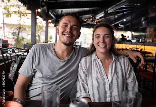 Portrait of a young couple smiling after having lunch in a restaurant