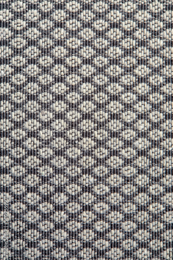 Knitted texture. Texture of jacquard fabric with gray geometric pattern. Crochet mosaic pattern
