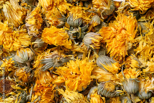 Medicinal flowers of a calendula on white background. Herbal tea. Top view. Close up. High resolution