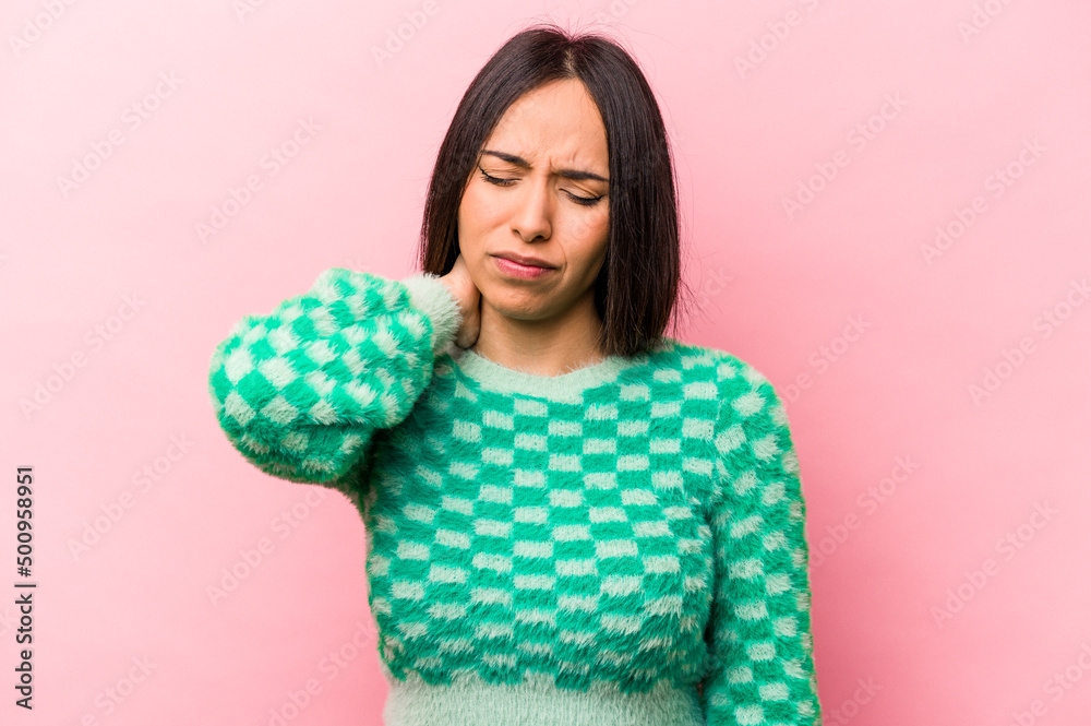 Young hispanic woman isolated on pink background having a neck pain due to stress, massaging and touching it with hand. Young hispanic woman isolated on pink background having a neck pain due to stress, massaging and touching it with hand.
