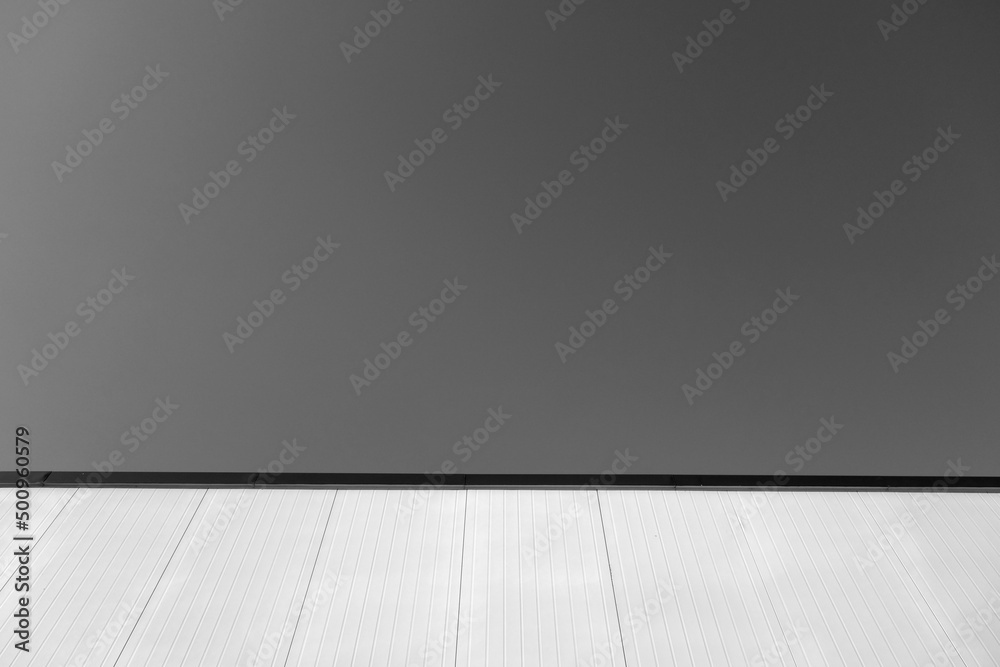 Commercial warehouse aluminium wall and roof against sky. Black and white