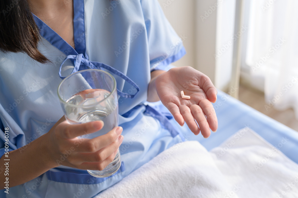 A young patient is eating medicine in hospital , healthcare and medical concept A young patient is eating medicine in hospital , healthcare and medical concept