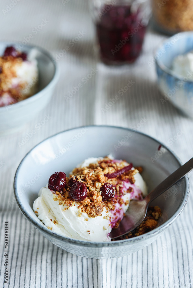 Cherry sauce, cream cheese and feta cream and crumble crust dessert. Homemade Sweet and salty cheesecake. Trifle. Selective focus Cherry sauce, cream cheese and feta cream and crumble crust dessert. Homemade Sweet and salty cheesecake. Trifle. Selective focus