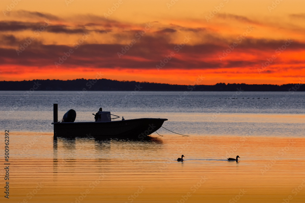 Fishing boat anchored, against a sunset sky, in North Carolina's Currituck Sound 