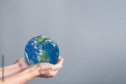 Hands holding earth globe on gray background, International human solidarity day concept, world health day, safe world concept with copy space, Elements of this image furnished by NASA