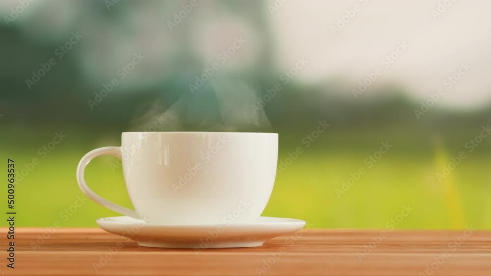 Hot tea in white cup on a wooden table. Tea ceremony process, healthy morning, freshly brewed detox drink. Hot tea in white cup on a wooden table. Tea ceremony process, healthy morning, freshly brewed detox drink.