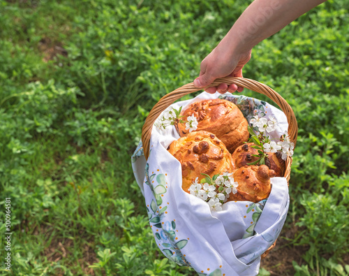 basket with Orthodox Easter pastries on a green meadow