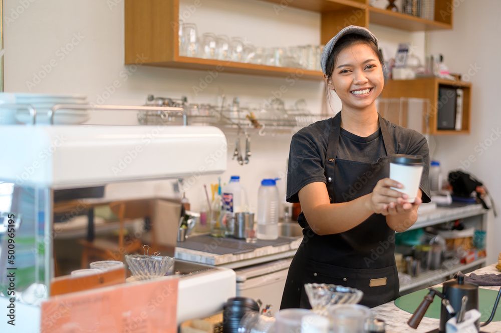 Young service minded barista woman working in coffee shop Young service minded barista woman working in coffee shop