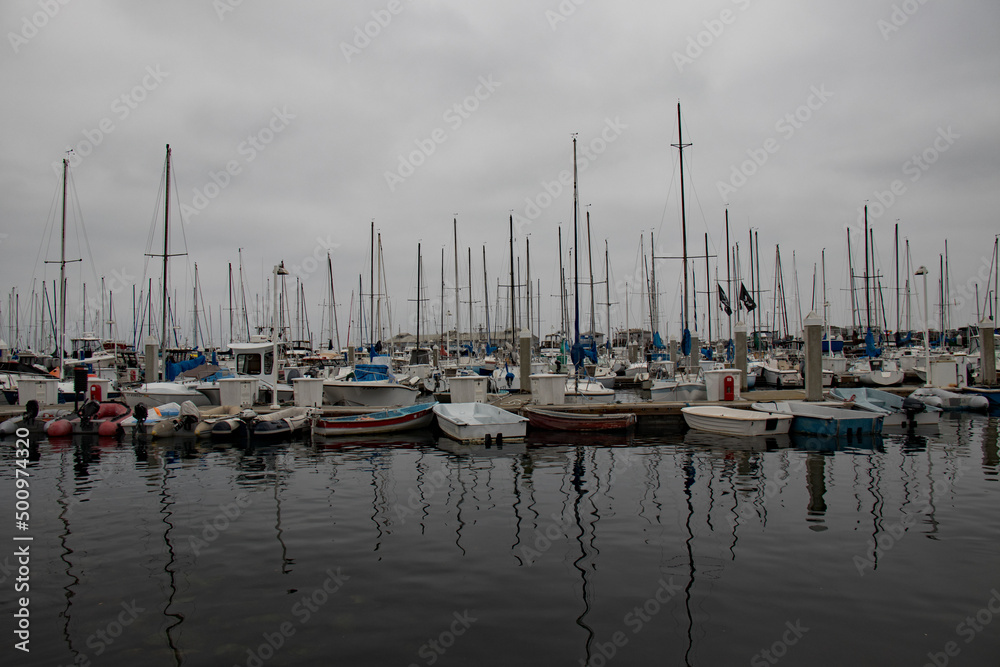 boats in the harbor under a gray sky