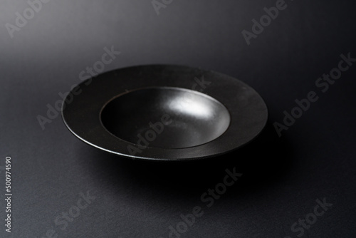 Empty black ceramic cereal or soup bowl prop