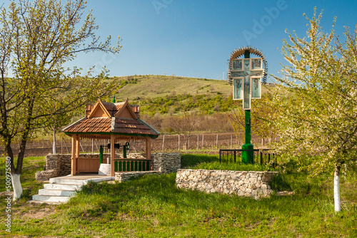 Moldova - Old Orhei - Worship cross and water well on the local crossroad near the archeological site Old Orhei, national moldavian heritage photo