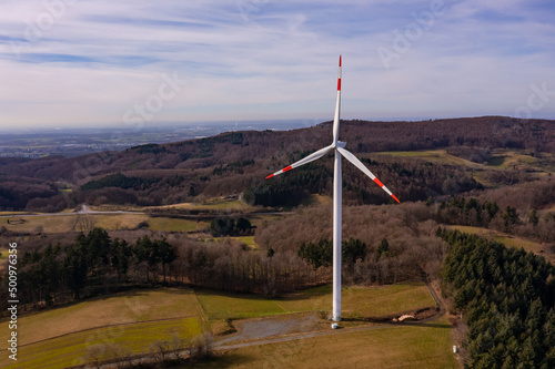 Aerial view of a single wind turbine in a rural region