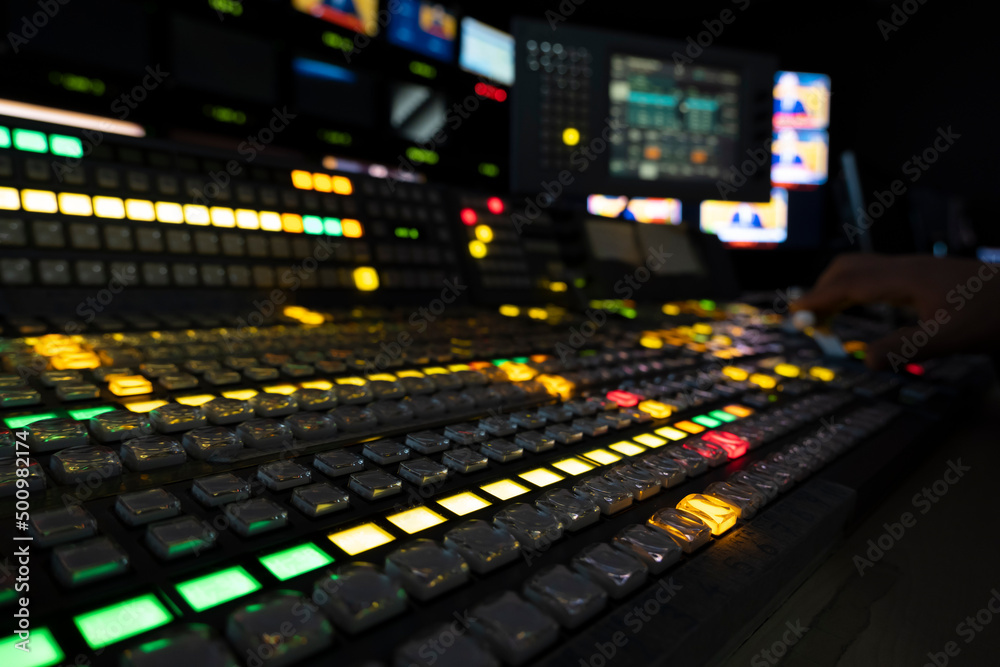 TV editor working with vision mixer in television broadcast gallery
