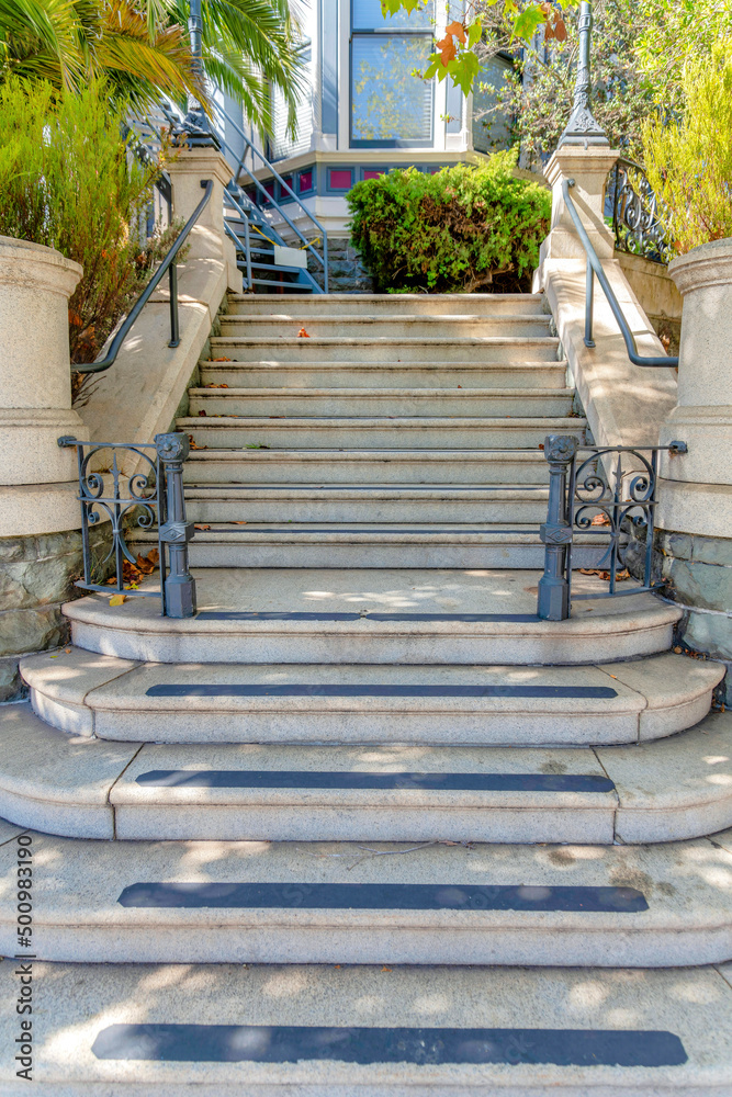 Perron staircase with anti-slip strips on each steps and metal fence and handrails Perron staircase with anti-slip strips on each steps and metal fence and handrails