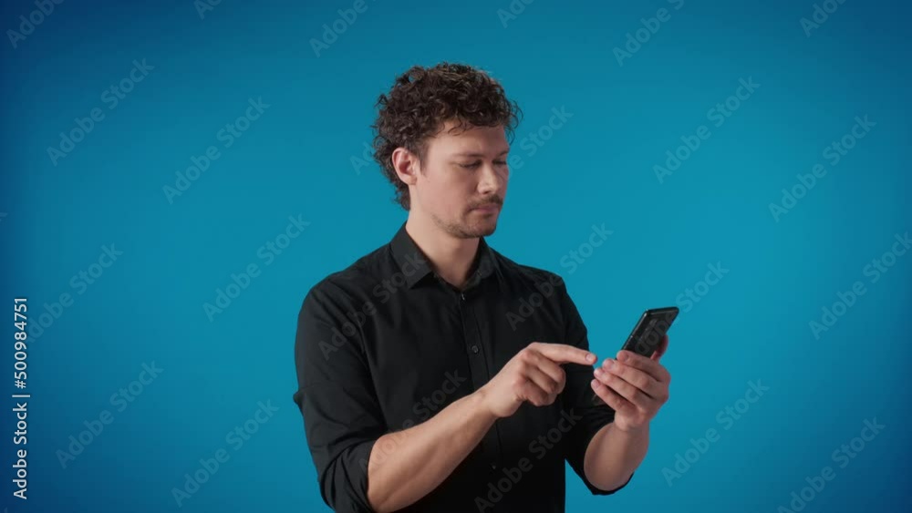 Successful fashion modern man use smartphone dating application pointing touchscreen posing Successful fashion modern man use smartphone dating application pointing touchscreen posing