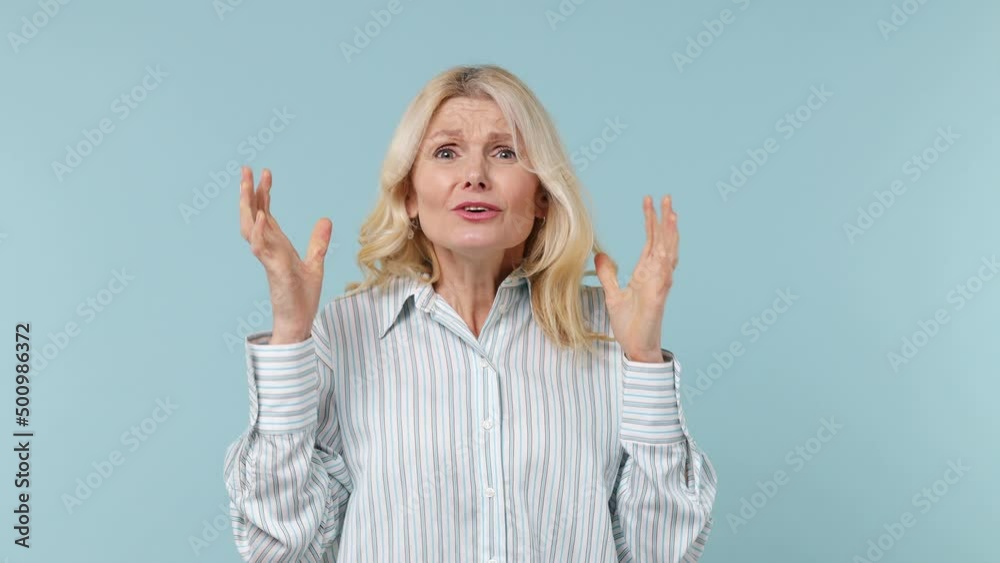 Gambling sport fan elderly gray-haired blonde woman lady 40s years old wears white shirt wait for special moment see loss wave hand sadly isolated on plain pastel light blue background studio portrait Gambling sport fan elderly gray-haired blonde woman lady 40s years old wears white shirt wait for special moment see loss wave hand sadly isolated on plain pastel light blue background studio portrait