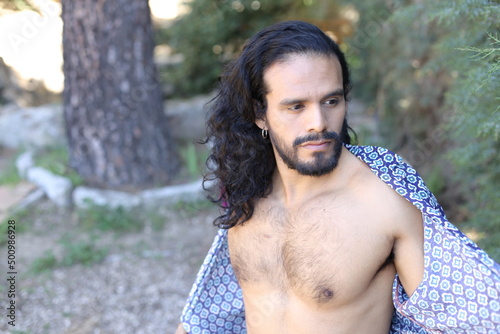 Beautiful long haired dancer showing muscular torso