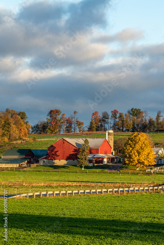 Red barn on an Amish Farm in the peaceful countryside under a partly cloudy sky | Holmes County, Ohio