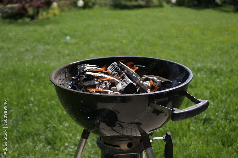 Barbeque grill heating up with charcoals on a suny day Barbeque grill heating up with charcoals on a suny day
