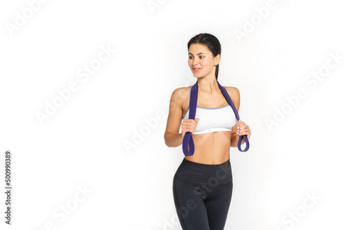 motivated awesome slim woman exercising fitness resistance bands, full length side view photo.