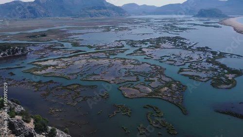 Aerial Survay Over the River Dalyan. Iztuzu Sand Spit Separates the River and the Sea. Tourist Boat Sailing on the River. Birds Eye View 4k photo