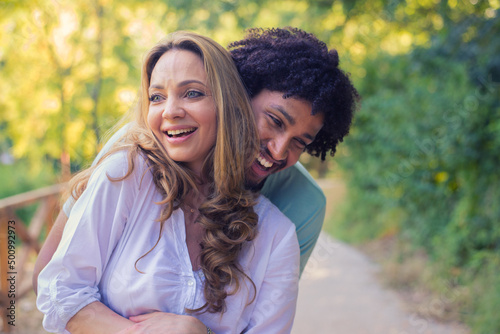 Young couple hugging in the nature on a sunny summer day