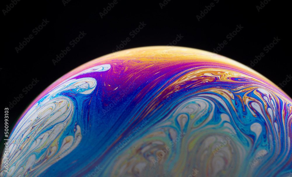 Half a soap bubble. Close-up. Black background. Bright colors. Side view. Imitation of an unknown planet. Science fiction Half a soap bubble. Close-up. Black background. Bright colors. Side view. Imitation of an unknown planet. Science fiction