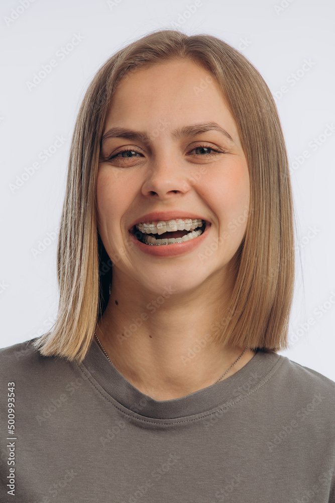 portrait of a young beautiful girl with braces, on a white background portrait of a young beautiful girl with braces, on a white background