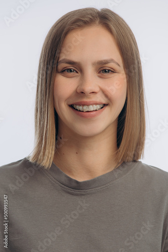 portrait of a young beautiful girl with braces, on a white background © mishadp