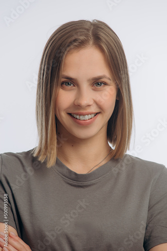 portrait of a young beautiful girl with braces, on a white background © mishadp