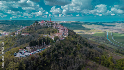 Aerial drone view of magnificent village of Motovun in Croatian Istria on a sunny day with cute fluffy clouds. Idyllic view of picturesque istrian village.ž